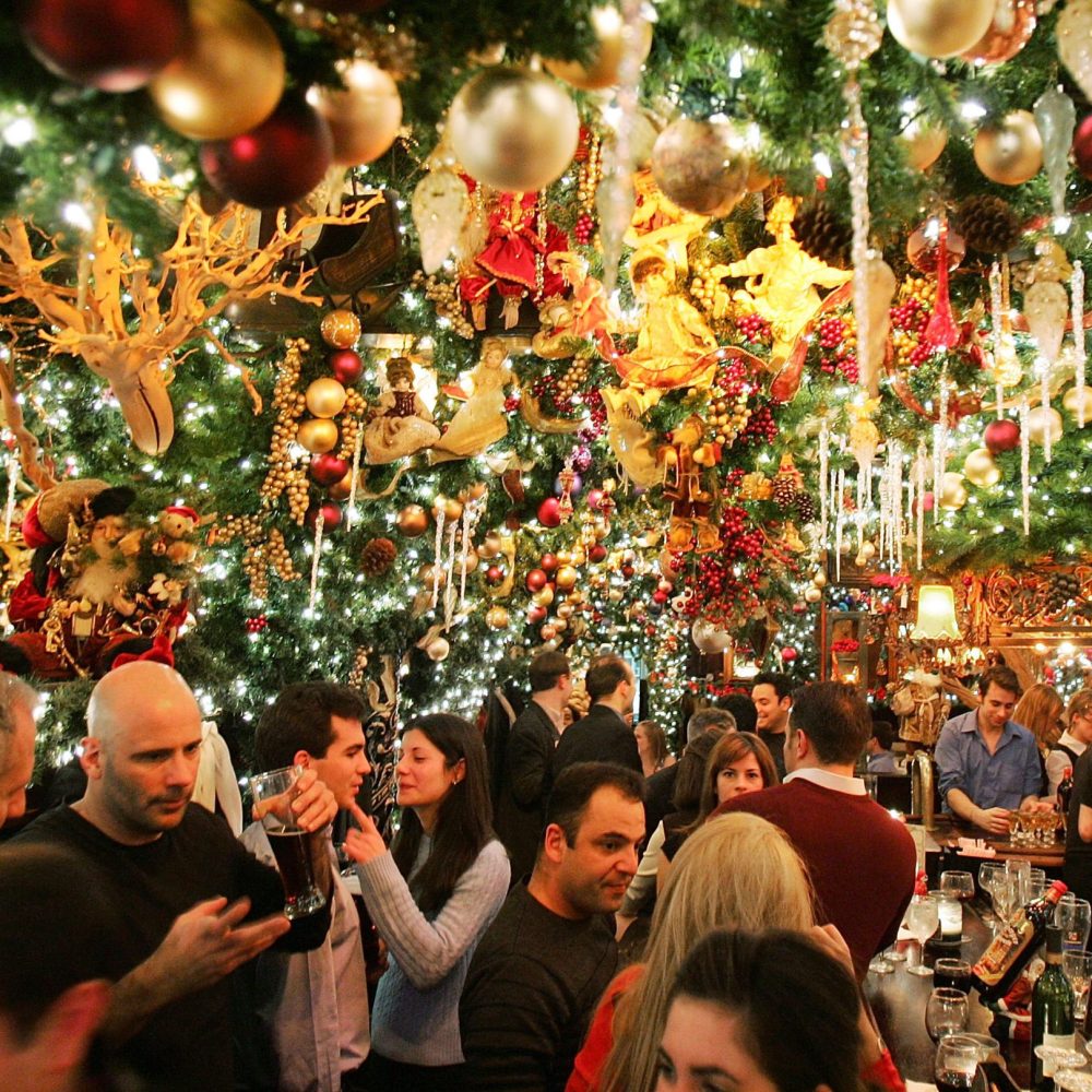 NEW YORK - DECEMBER 22:  Patrons enjoy the traditional Christmas "wunderland" decor in Rolf's German restaurant December 22, 2004 in New York City. The 19th-century German tavern decorates for the Christmas season with artificial fir trees and pine garlands, Victorian dolls and thousands of Christmas lights.  (Photo by Mario Tama/Getty Images)